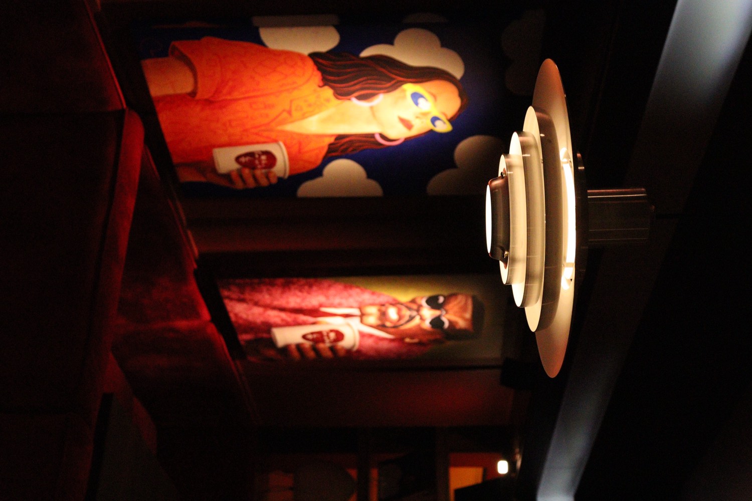 The painted panels along the banquette, lit after dark